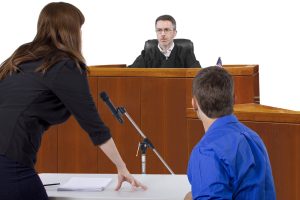 A courtroom scene with a judge, a lawyer, and a defendant engaged in a discussion.